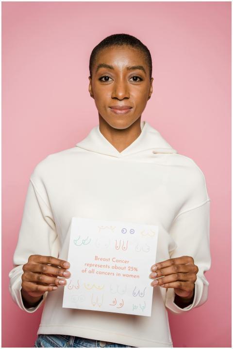 Confident African American woman holding sign to r