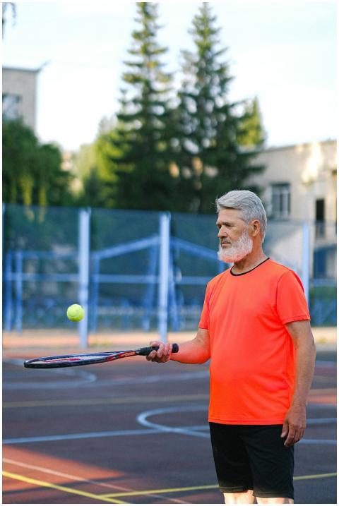 Senior man practicing tennis with focus and energy
