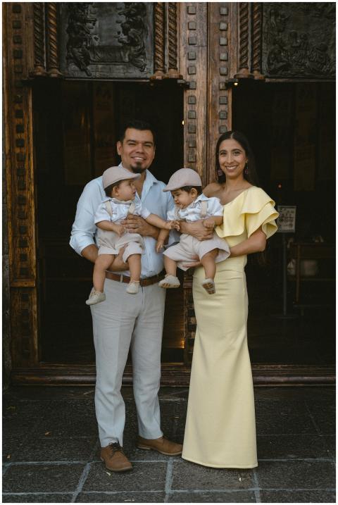 Happy family with twin boys posing at a church ent