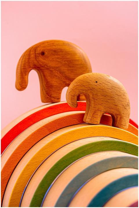 Close-up of wooden elephant figurines on a vibrant