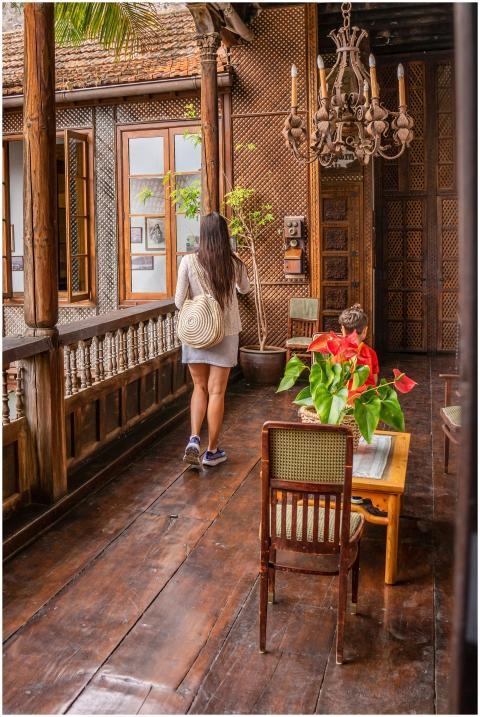 A woman walking on a rustic wooden balcony in La O
