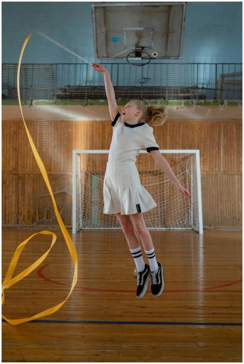 Energetic girl performing rhythmic gymnastics in a