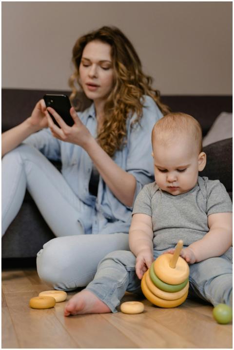 A mother and baby engage indoors, showcasing moder
