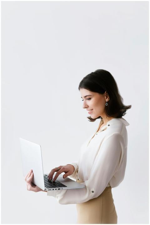 Side view of a businesswoman typing on a laptop ag