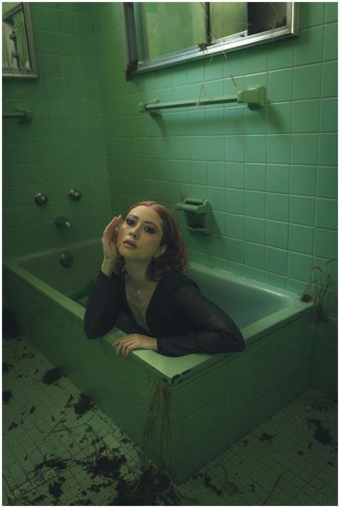 Artistic portrait of a woman in a vintage green ti