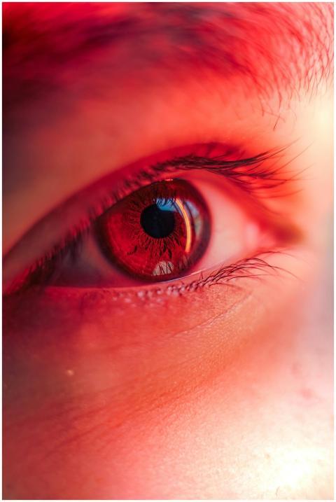Macro shot of a human eye with a striking red hue,