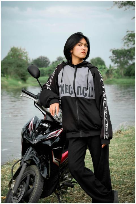 A young adult in casual attire posing confidently