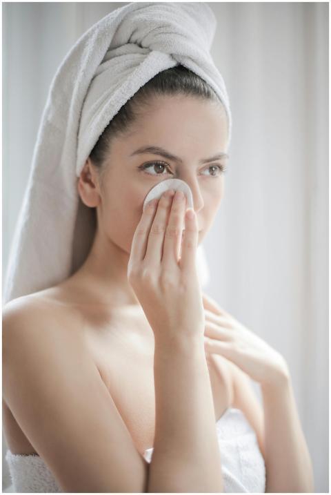 Young female after shower with towel on head using