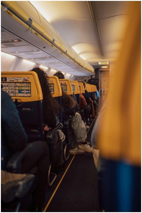 Interior view of an airplane with passengers seate