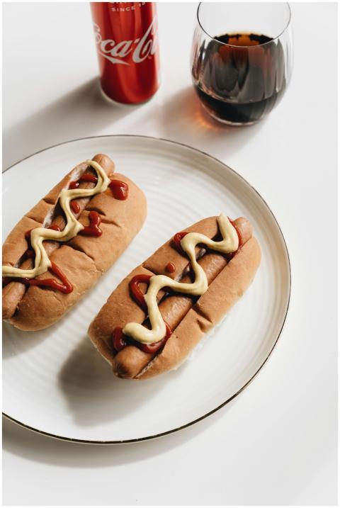 Tasty hot dogs with mustard and ketchup, served wi