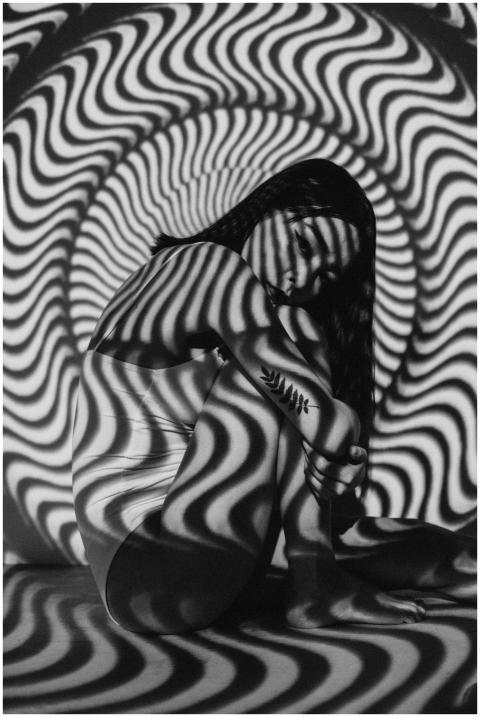 A woman enveloped in a geometric black and white o