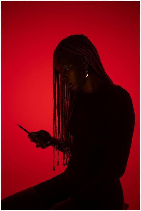Silhouette of a woman with braids focused on her c