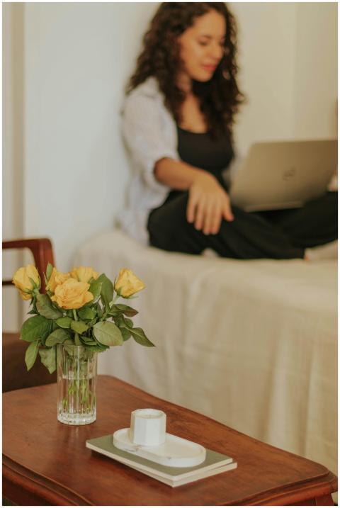 Young woman sitting with a laptop in a cozy room f