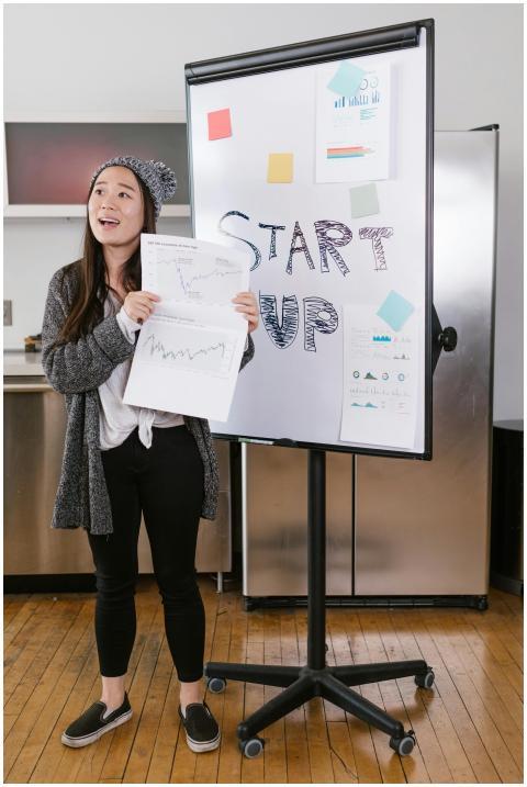 A young woman gives a startup presentation with ch
