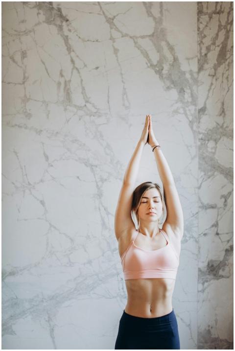 Young woman performing upward salute yoga pose ind