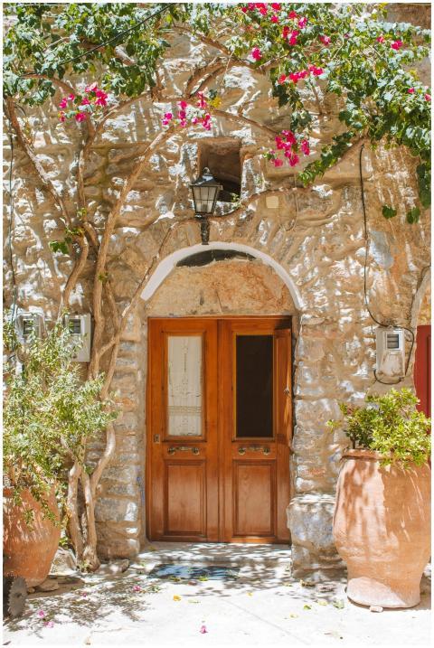 A rustic stone house entrance adorned with vibrant