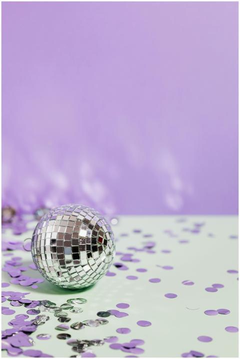 Silver disco ball amid vibrant purple and green co