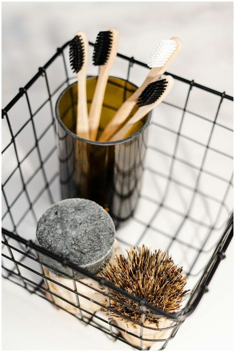 A minimalist wire basket with bamboo toothbrushes
