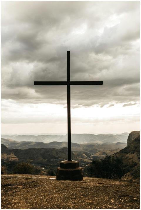 A powerful silhouette of a cross set against a dra