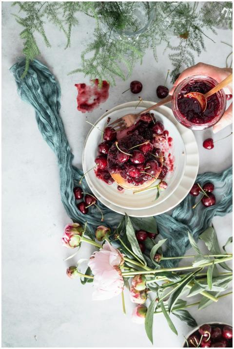 Top view of pancakes drizzled with cherry compote