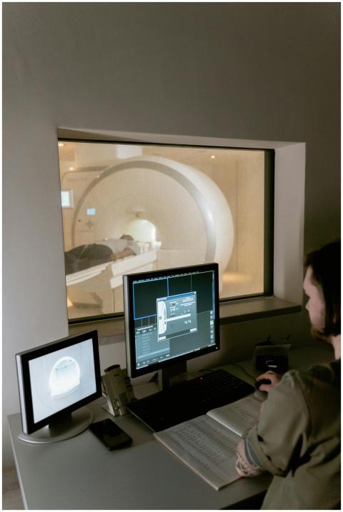 Health worker examines MRI scan data in a clinical