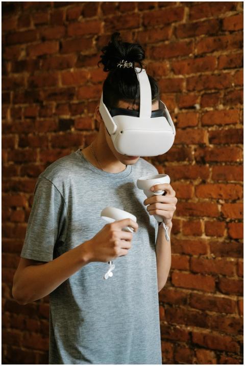 Young adult with VR headset playing a virtual real