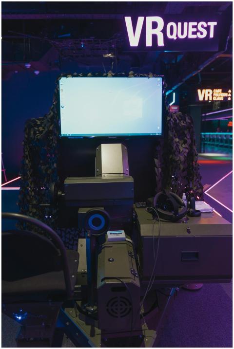 Futuristic VR gaming setup with headset and monito