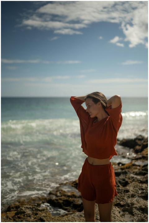 Caucasian woman in red outfit enjoying the beach w