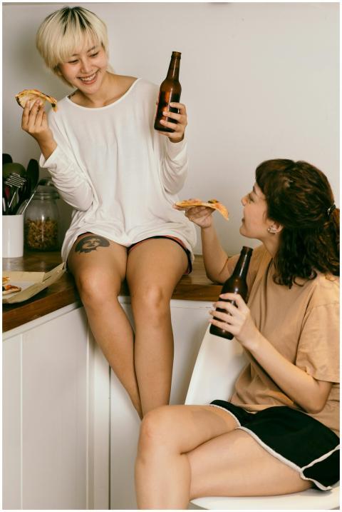 Happy female hipster enjoying slice of pizza and d