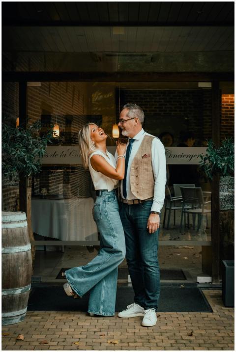 Couple sharing a joyful moment outside a restauran