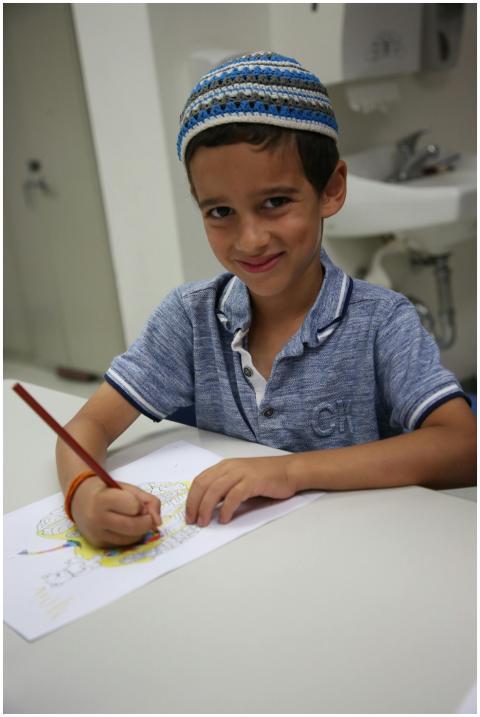 A cheerful child engaging in creative drawing at a