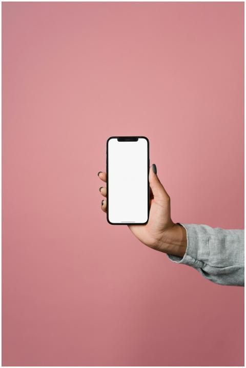 Close-up of a hand holding a smartphone with a bla