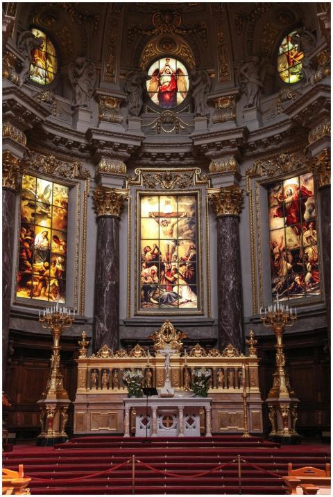 An elaborate church altar adorned with gold and in
