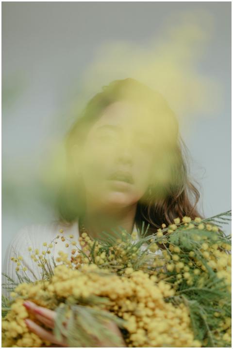 Artistic portrait of a woman obscured by delicate