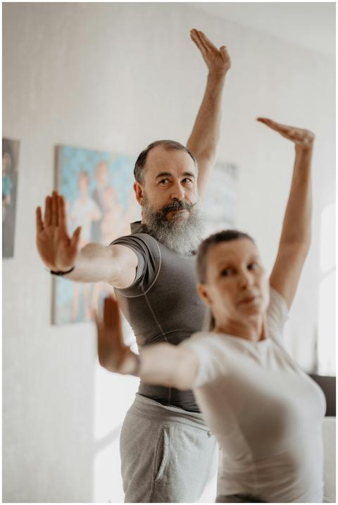 Senior couple engaging in yoga exercises indoors,