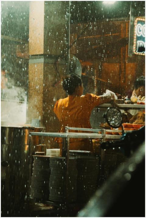 Street food vendor preparing dishes at night under