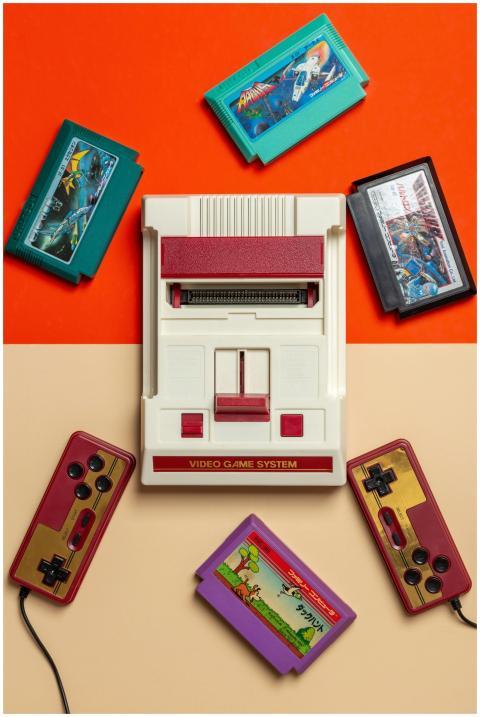 Flat lay of vintage video game console with colorf