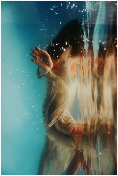 Artistic underwater portrait of a woman in flowing