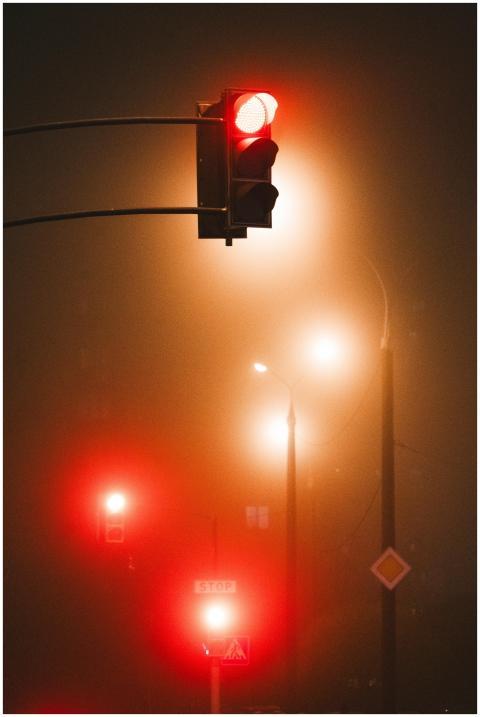 Eerie city nightscape featuring glowing red traffi