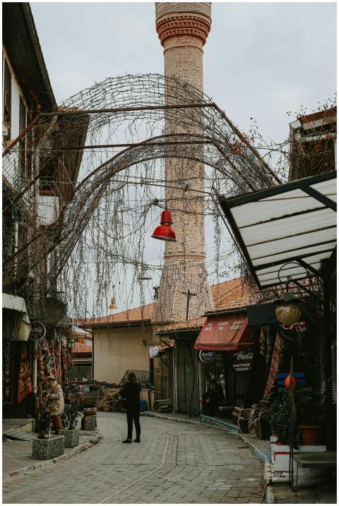 Busy market street with minaret tower, vibrant sho