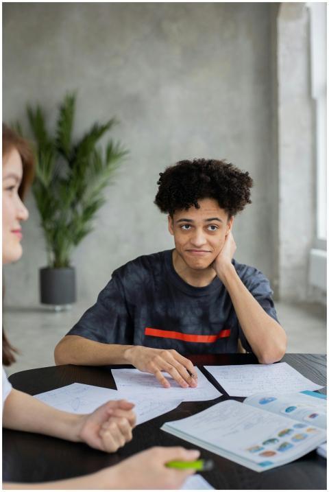 African American male student sitting at table wit