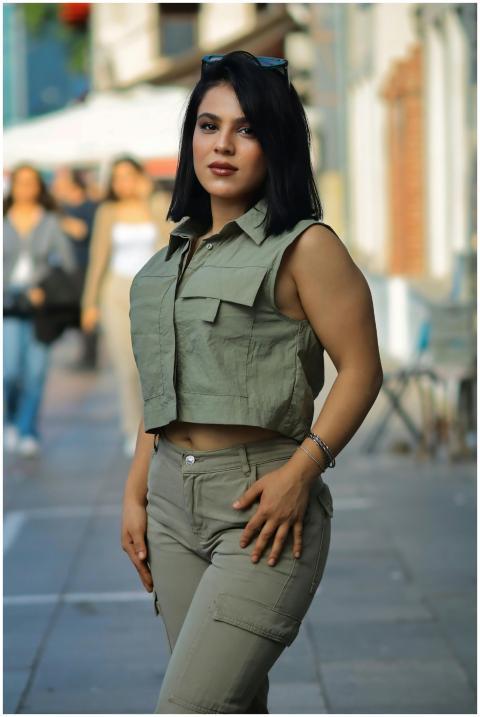 Confident woman in stylish outfit poses on an urba