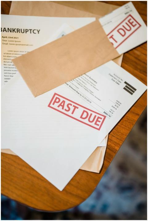 Photograph showing past due and bankruptcy documen