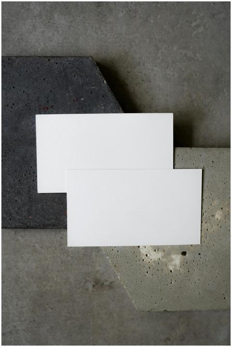 Simple flat lay of blank business cards on texture