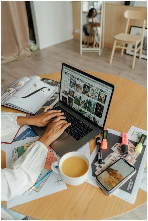 A person working from home with a laptop, coffee,