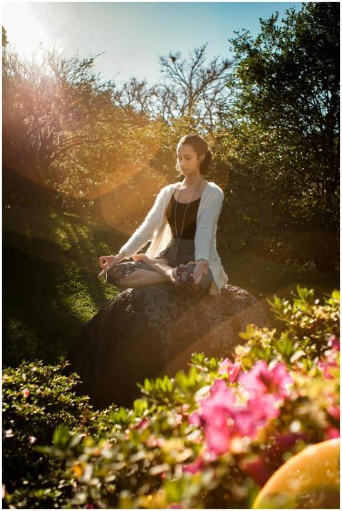 Woman in tranquil meditation pose outdoors, bathed