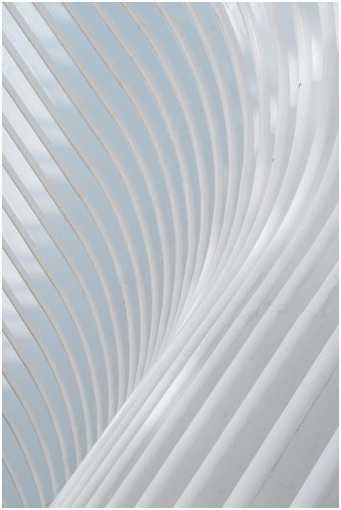 A modern white curved architectural structure with