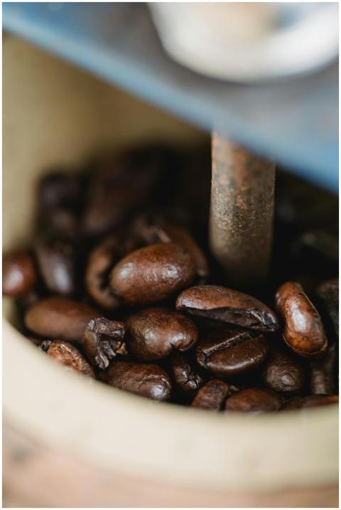 Macro shot of brown coffee beans in an antique gri