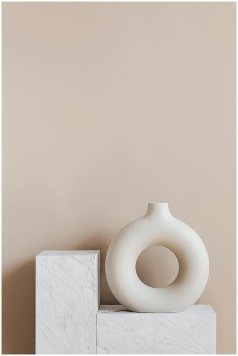 White ceramic vase in creative shape of ring place