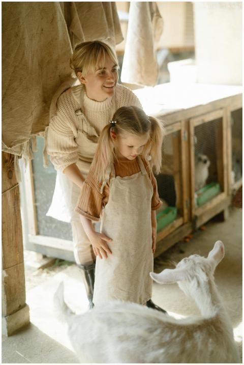 A mother and her daughter standing together in a g